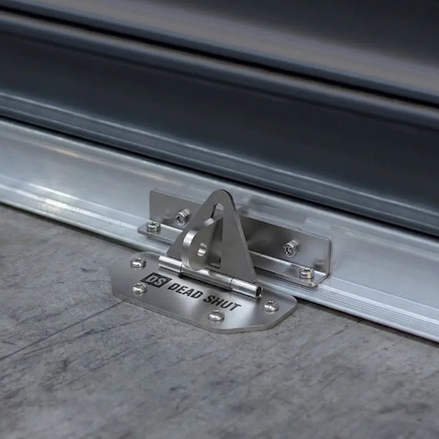 Dead Shut roller door anchor fitted between the bottom rail and concrete slab